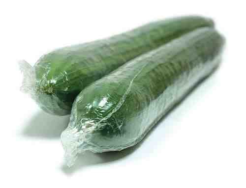 Two shrink wrapped cucumbers.